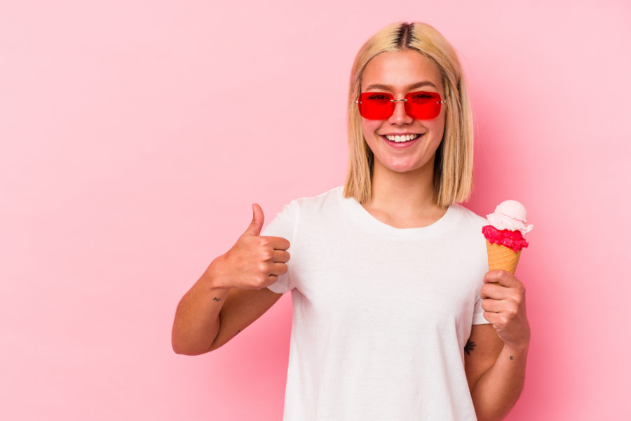 woman with ice cream cone and thumbs up, giving approval