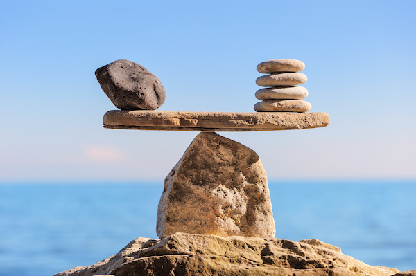 picture of one large stone and multiple small stones in balance