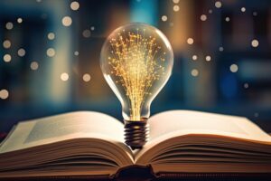 Light bulb on open book reading for inspiration and new ideas