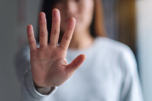 woman with hand up signaling to keep away